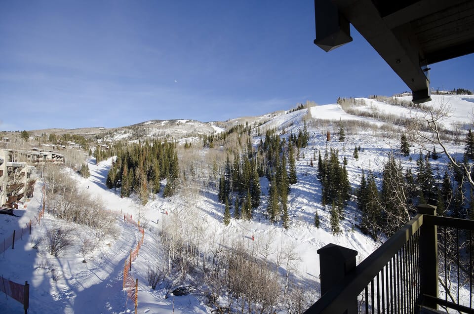 Stunning ski slope views stretch across snow-covered mountains from your private balcony, creating a perfect winter mountain retreat.