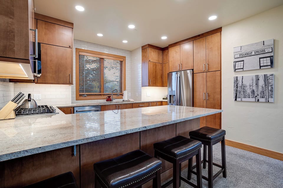 Your gourmet kitchen features granite countertops, stainless steel appliances, and a breakfast bar for casual dining.