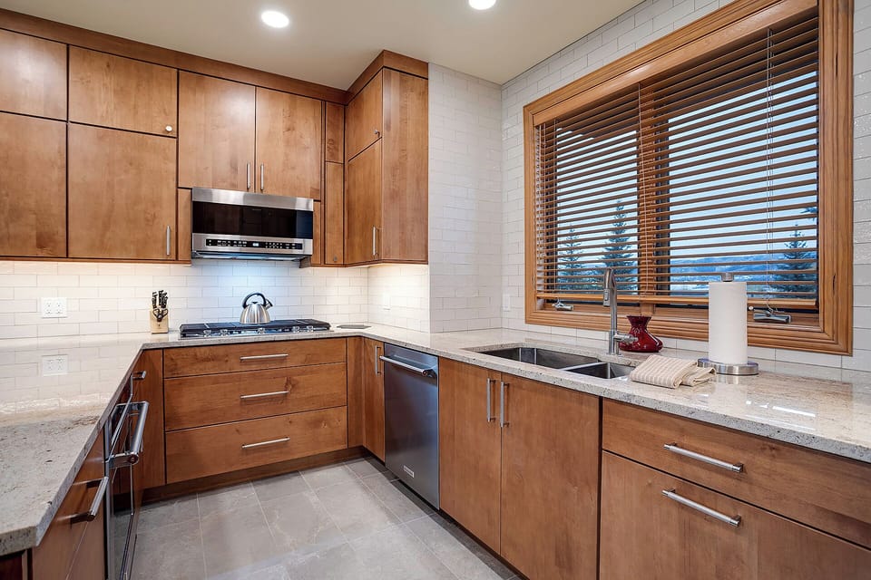 Step into your chef's paradise with warm wood cabinets, granite counters, and modern appliances ready for your culinary adventures.