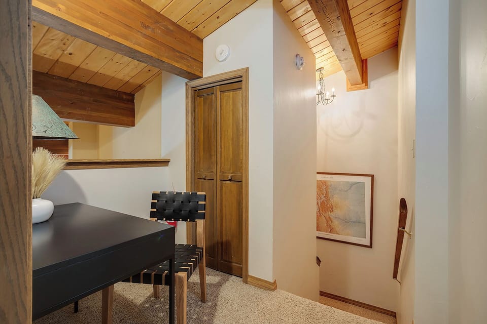 Savor intimate meals beneath stunning exposed beams in your private dining nook, where rustic charm meets modern comfort.