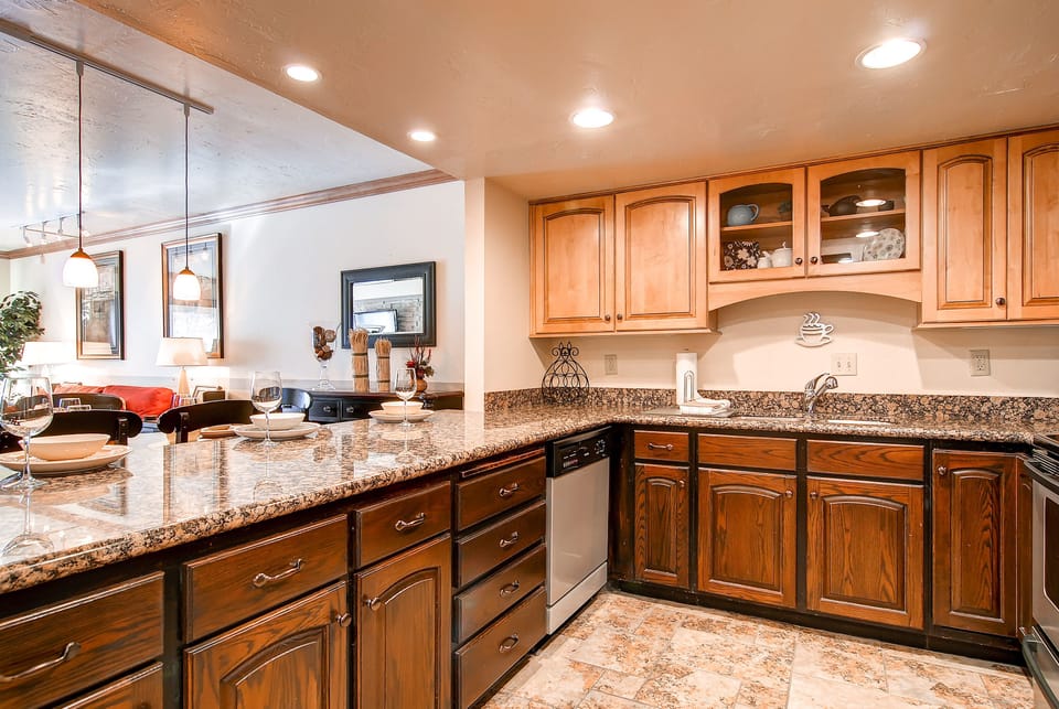 The well-equipped kitchen has wood cabinets and stainless steel appliances.