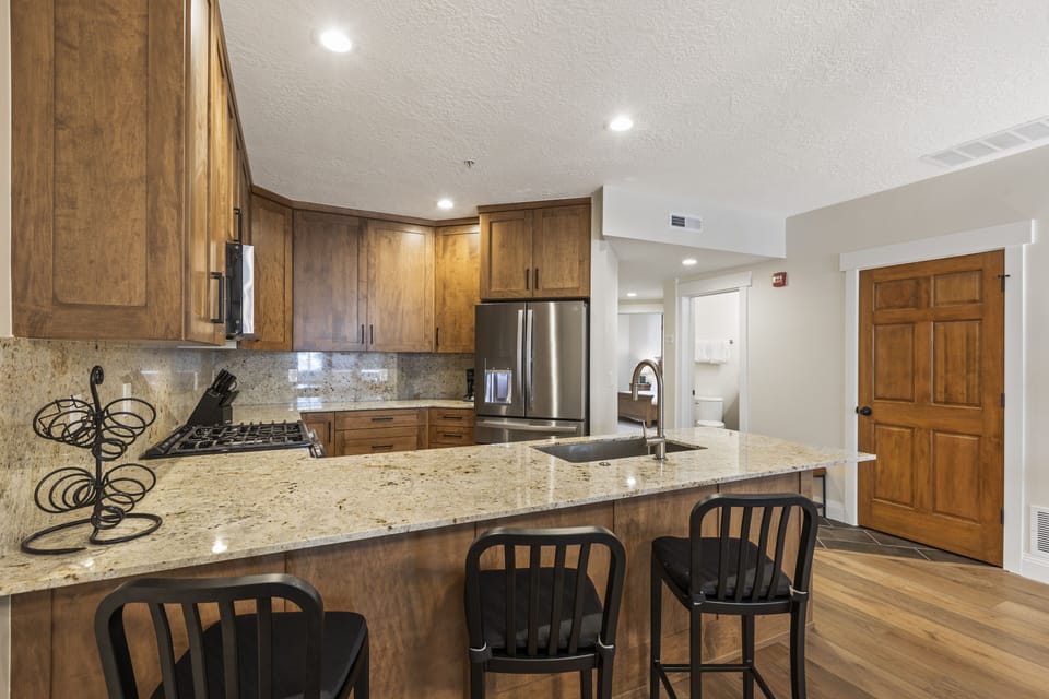 The well-equipped kitchen has a breakfast bar with seating for three.