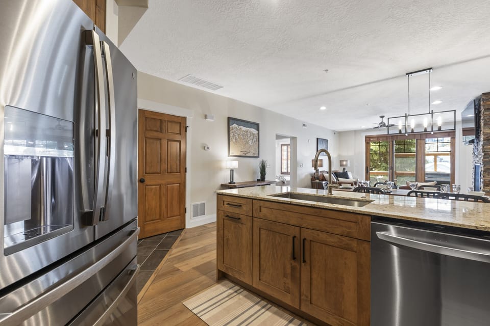The well-equipped kitchen has beautiful wood cabinets and stainless steel appliances.