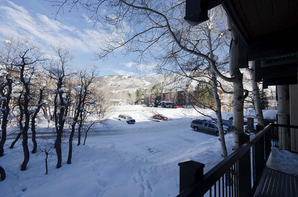 Snow-covered mountain landscape views with parking area and winter trees surrounding the property location.