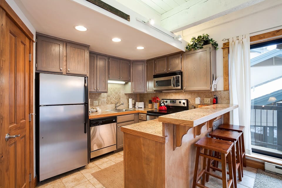 Your fully equipped kitchen features granite countertops, stainless appliances, and a breakfast bar where you can start each morning with coffee.