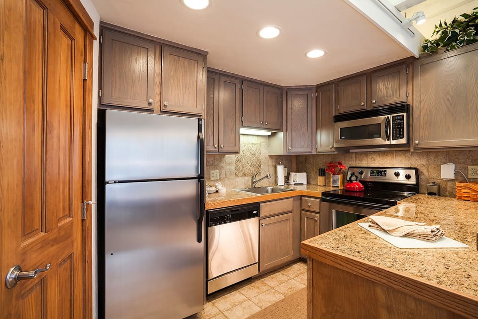 Your fully equipped kitchen features granite counters, stainless steel appliances, and everything needed to create memorable meals during your stay.