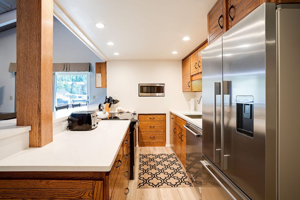 Cook up your favorites in this gorgeous kitchen with rich wood cabinets, gleaming counters, and top-tier stainless appliances.