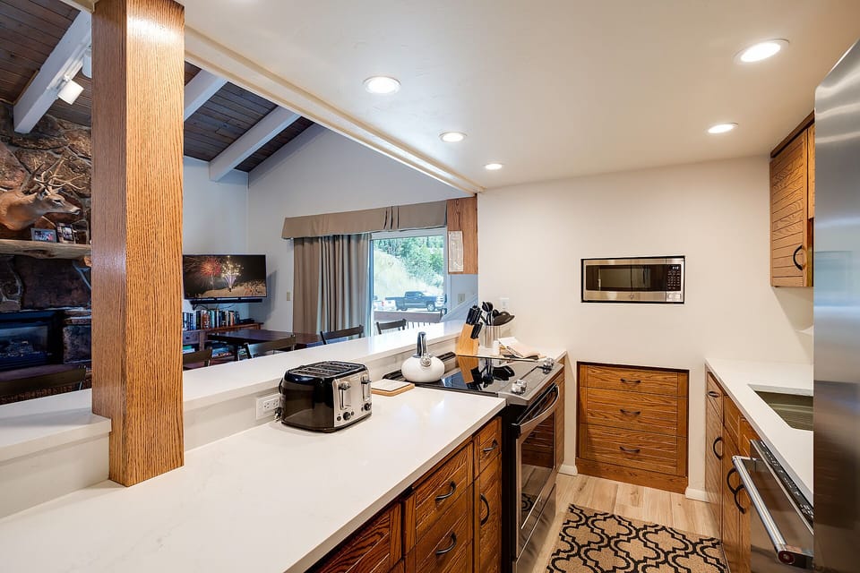 Your gourmet kitchen features beautiful wood cabinets, modern appliances, and spacious counters perfect for preparing memorable meals together.
