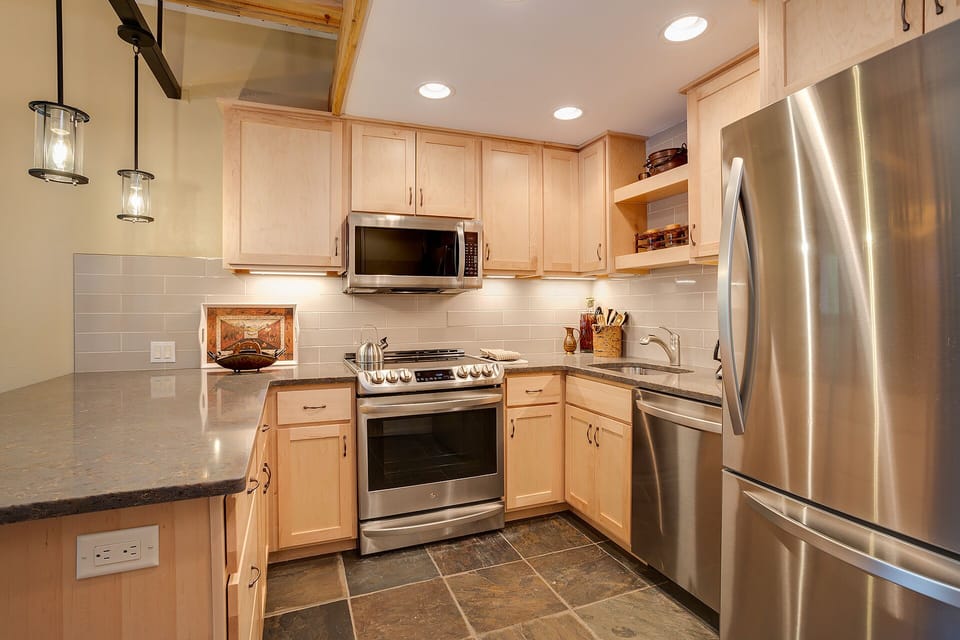 Step into your fully equipped kitchen with granite counters, stainless steel appliances, and modern conveniences for memorable meal preparation.