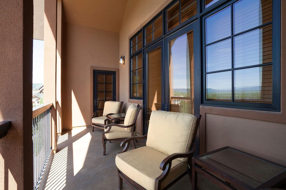 Unwind on your private balcony with comfortable seating while soaking in the breathtaking mountain views through floor-to-ceiling windows.