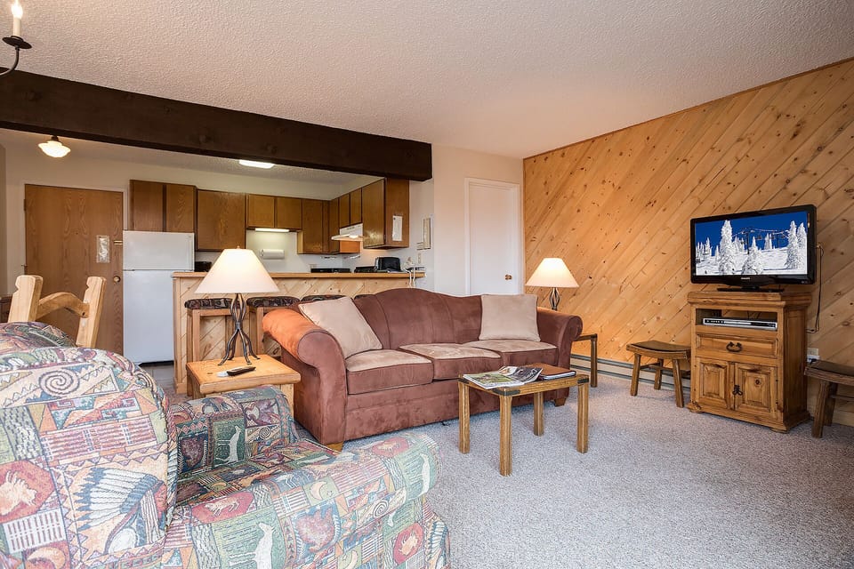 Relax in your cozy mountain retreat with warm wood accents, plush seating, and a fully equipped kitchen for home-cooked meals.