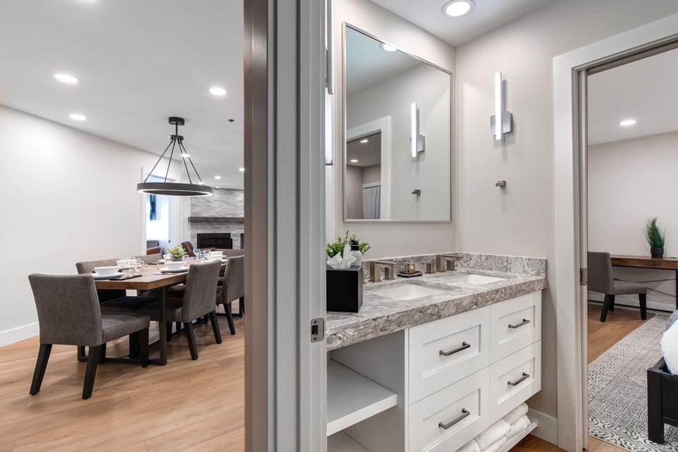 The shared bathroom offers a double sink vanity.