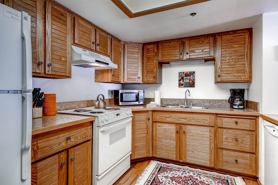 Park Station 218 has a well-equipped kitchen with wood cabinets.