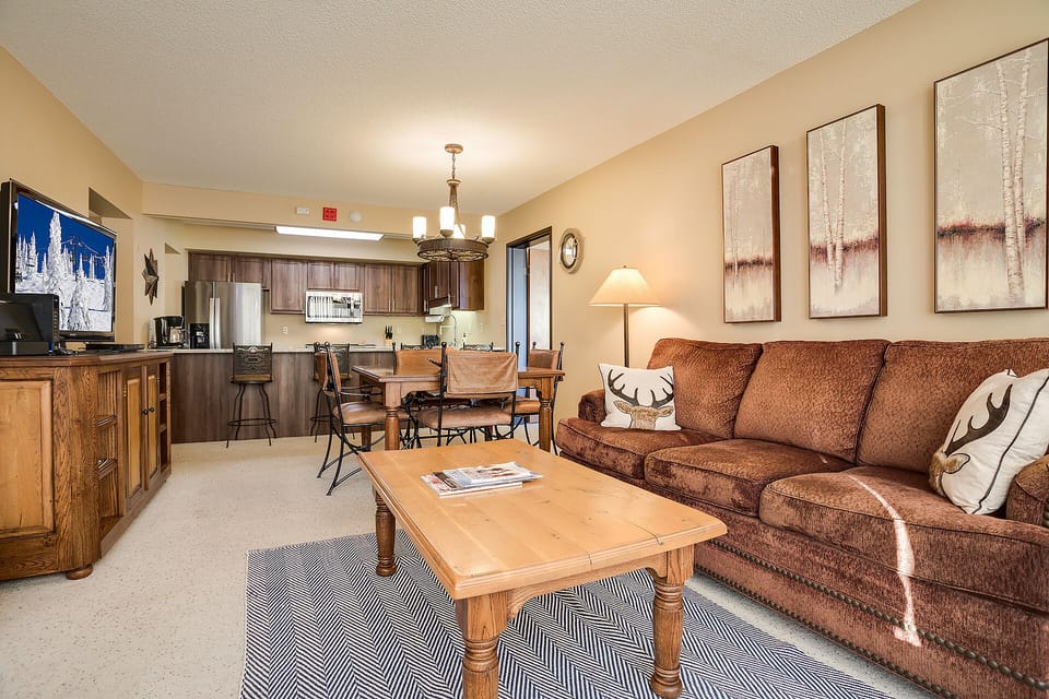 Sink into plush brown sofas while enjoying your favorite show, then prepare meals in the fully equipped kitchen just steps away.