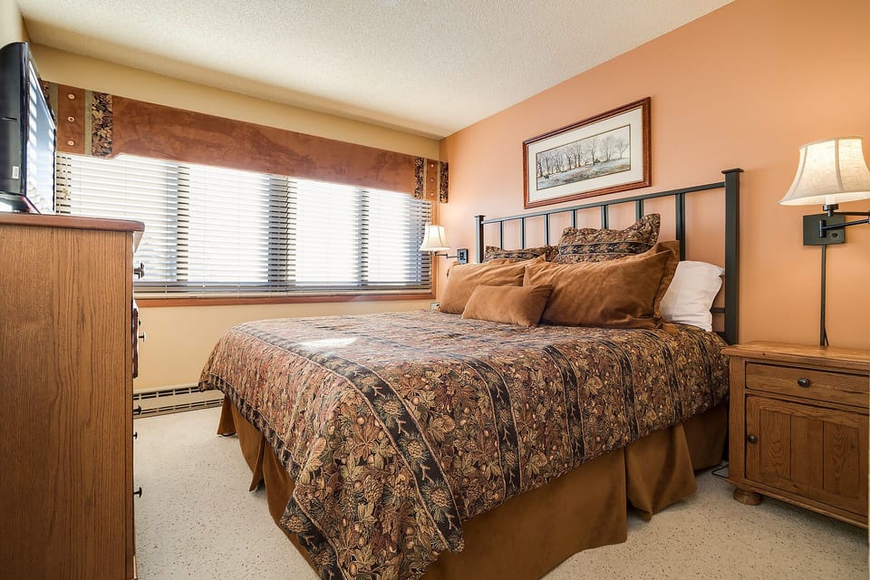 Unwind in your cozy bedroom featuring warm earth tones, comfortable bedding, and natural light streaming through the windows.
