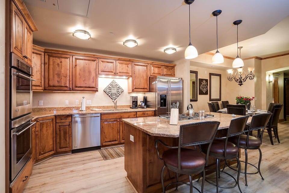 Your gourmet kitchen invites culinary adventures with rich wood cabinets, granite counters, and a spacious island perfect for morning coffee or evening gatherings.