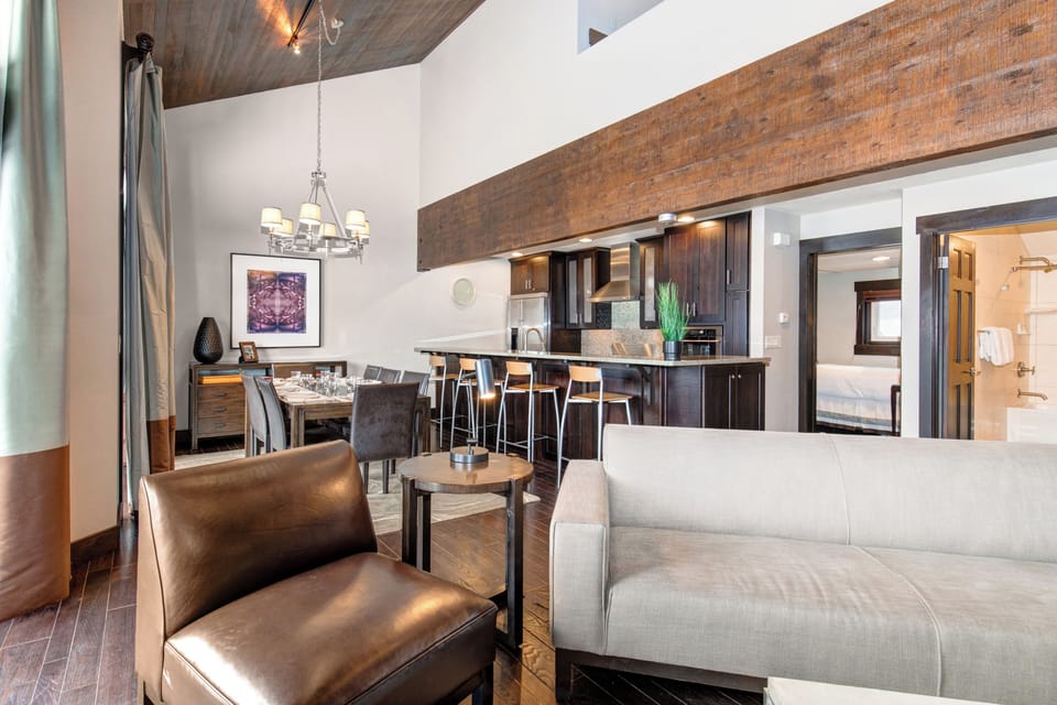 The open concept living room, dining and kitchen area with high ceilings.