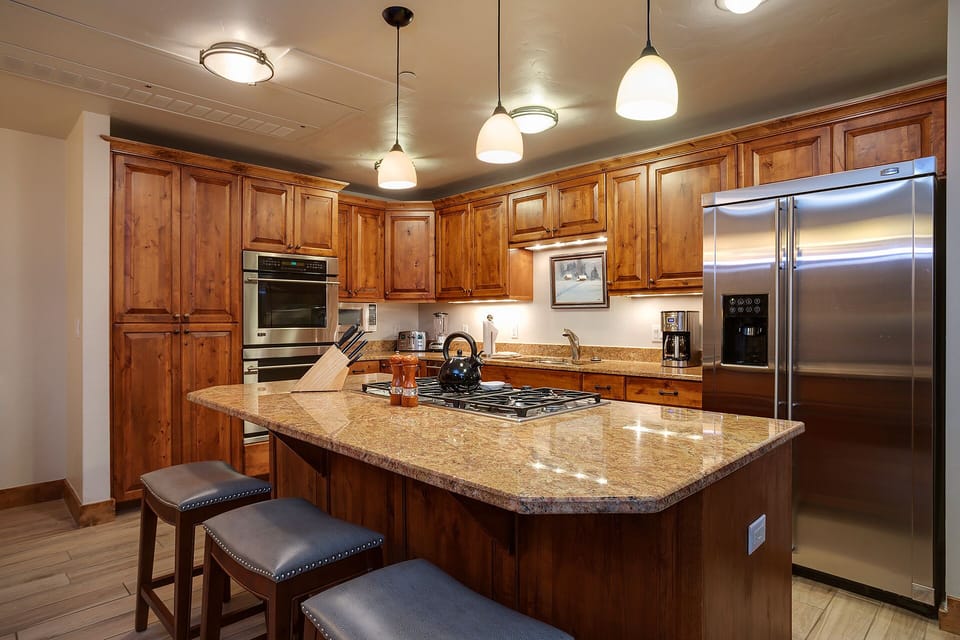 Your gourmet kitchen awaits with warm wood cabinetry, granite countertops, and premium stainless steel appliances for memorable meals.