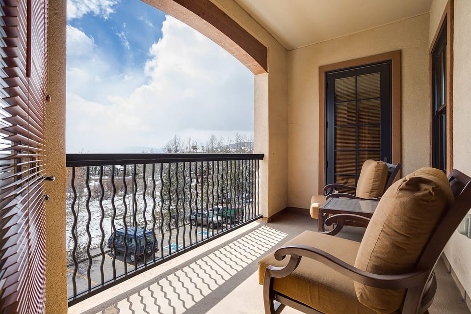 Your private balcony beckons with comfortable seating where you can unwind while taking in the peaceful views beyond.
