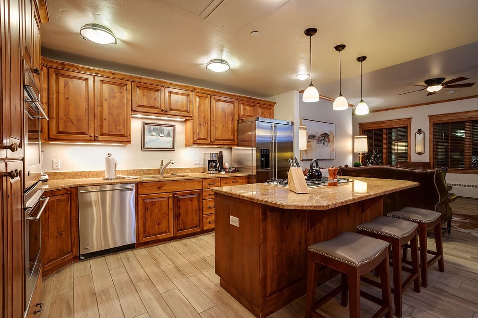 Your gourmet kitchen features rich wood cabinetry, granite countertops, and stainless steel appliances for effortless meal preparation.