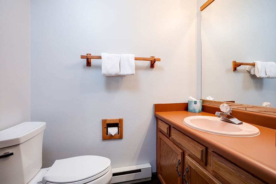 Your private bathroom features fresh towels, a vanity with counter space, and all the essentials for a comfortable stay.