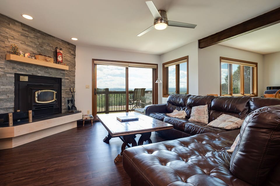 Sink into luxurious leather seating while your cozy fireplace warms the room and stunning mountain views stretch beyond the deck.