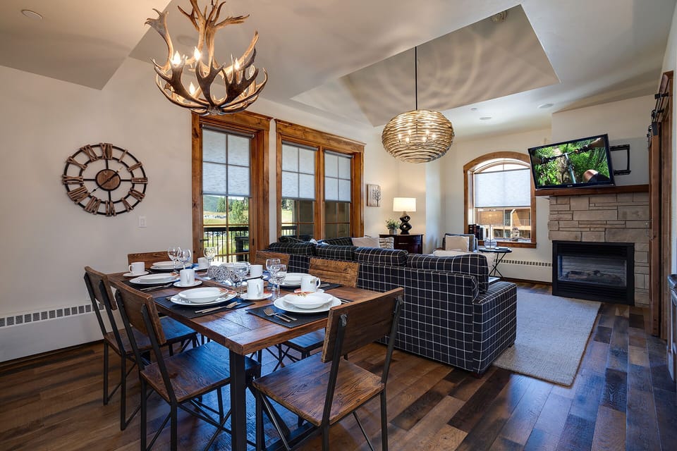 Sink into your plush bed beneath warm wood trim and modern art. Natural light spills through your window while the cozy sitting nook invites peaceful mornings with coffee.