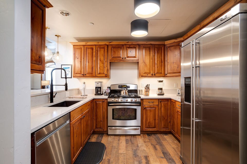 Cook memorable meals in your fully-equipped kitchen with warm wood cabinets, modern appliances, and granite countertops.