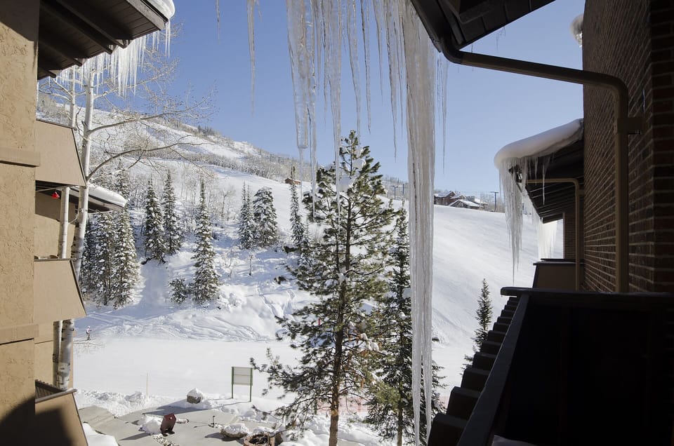 Winter wonderland views from your mountain retreat feature pristine snow-covered slopes and evergreen forests stretching to distant peaks.