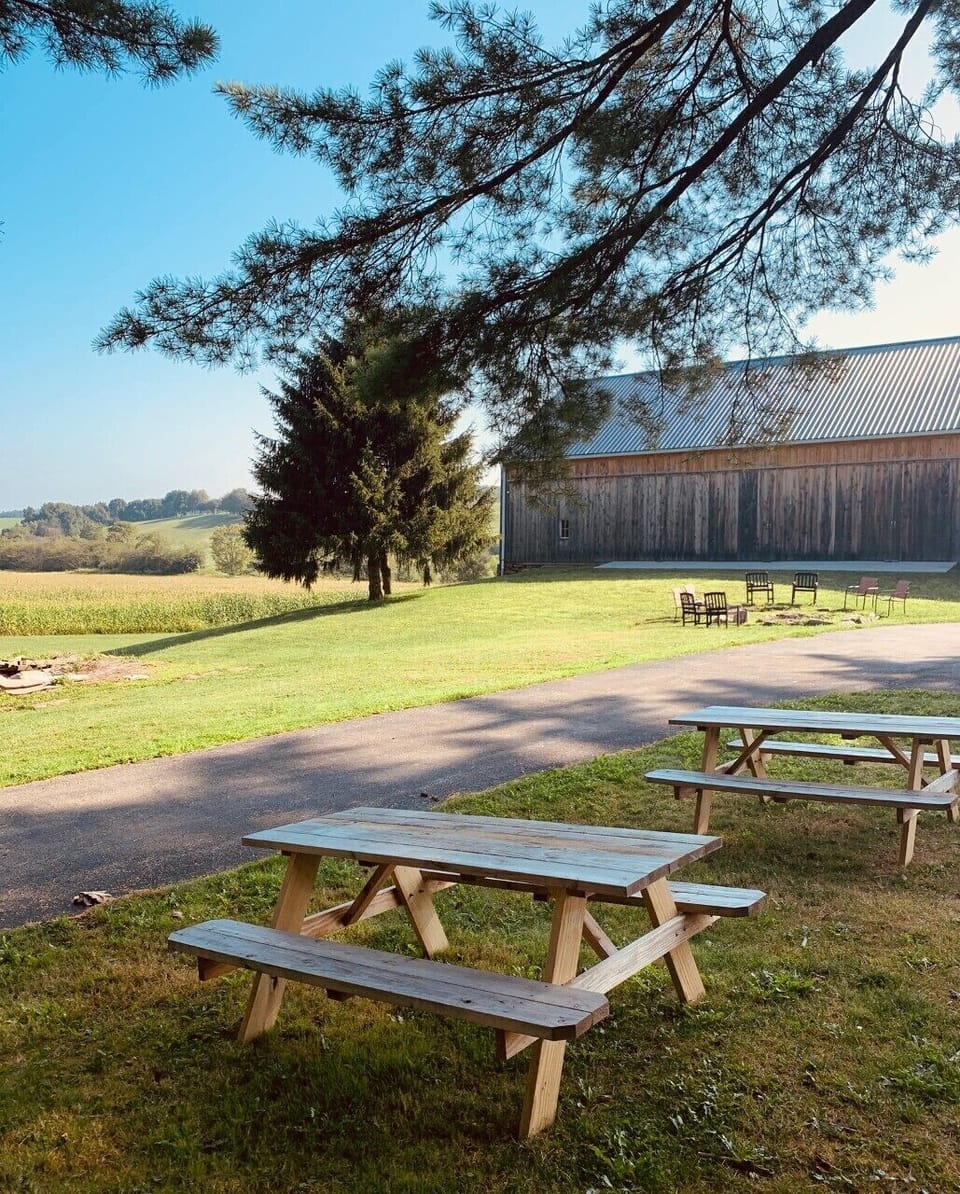 Several acres of land and picnic tables for enjoying the outdoors.