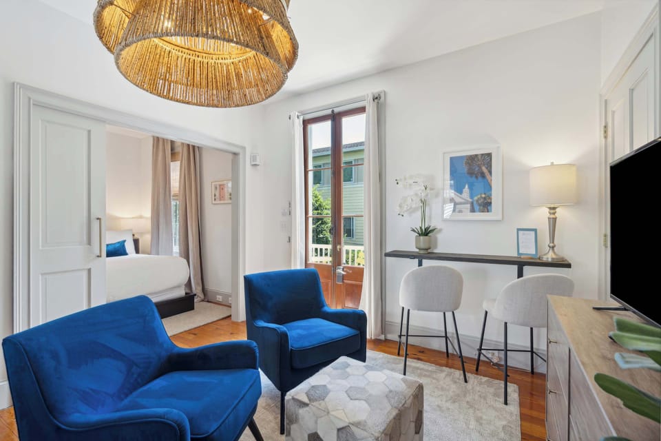 The cozy living area features vibrant comfortable velvet chairs. 