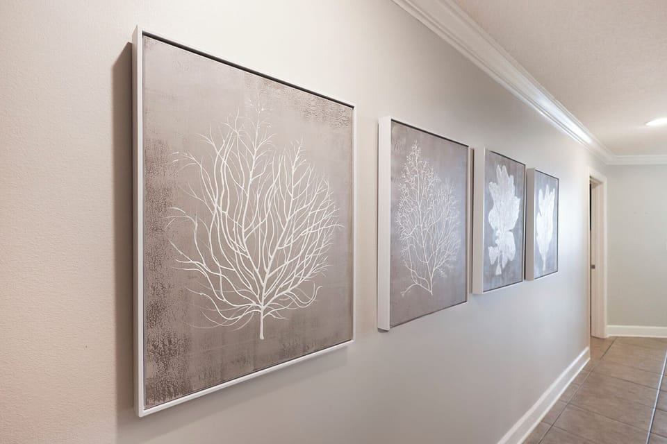 Admire the soothing coastal-inspired art while strolling through this inviting space, enhancing your beach vibe
