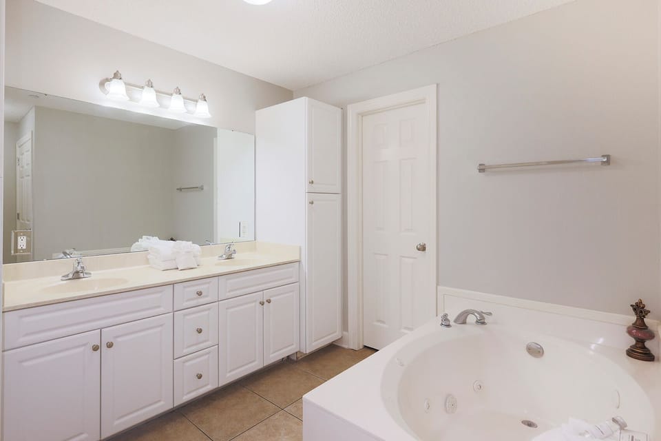 Refresh in the master bath after a day at the beach with a soothing jetted tub and relaxing walk-in shower