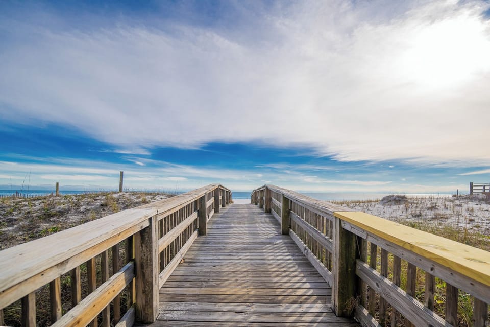 Walk along this charming boardwalk leading to the sandy beach, perfect for a relaxing day by the water