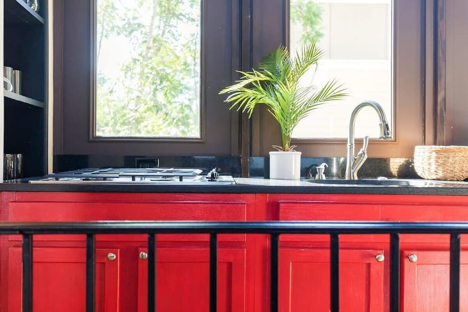 Kitchen features full sized fridge, dishwasher, gas cooktop, and electric oven. 
