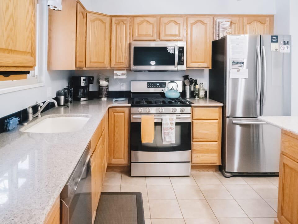 Toaster, coffee pot, blender, dishwasher, gas range, oven, microwave, fridge.