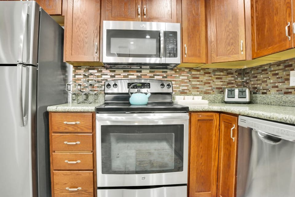 Park Station 113 has stainless steel appliances and wood cabinets.