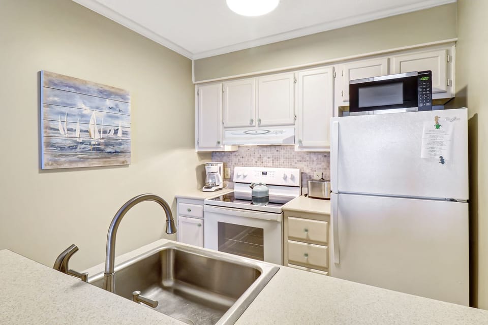 Kithcen area - Kitchen fully equipped with fridge, oven, dishwasher, coffee maker, microwave, toaster, utensils and more.