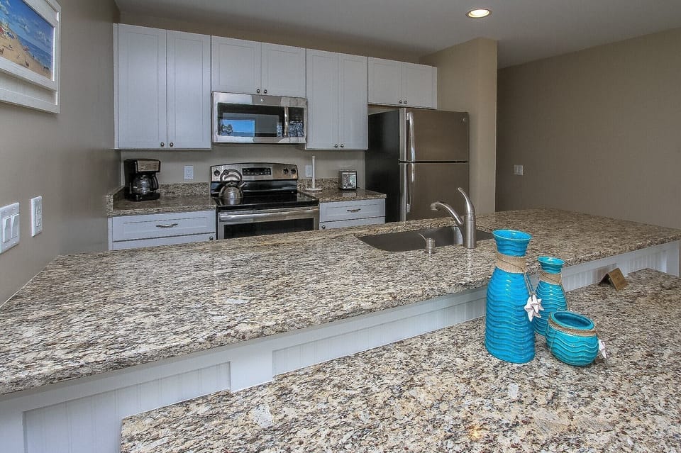 Ocean Dunes 316 - Fully Equipped Kitchen - The newly renovated Kitchen / Dining Area features all stainless appliances, granite counters and dining bar having seating for four, and tile flooring throughout.