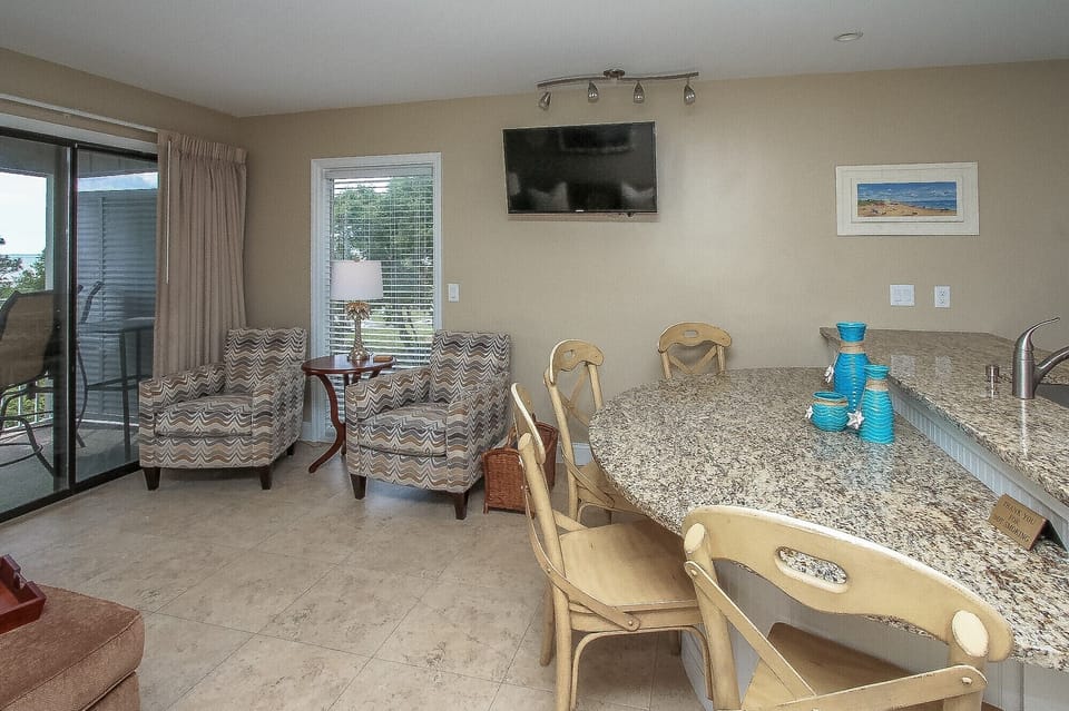 Ocean Dunes 316 - Living and Dining Area - The newly renovated Kitchen / Dining Area features all stainless appliances, granite counters and dining bar having seating for four, and tile flooring throughout.