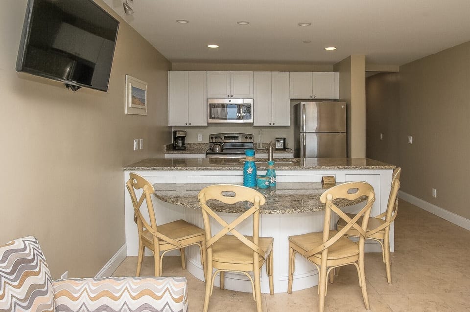 Ocean Dunes 316 - Dining Area with seating for Four - Completely furnished kitchen that looks to dining area and ocean view