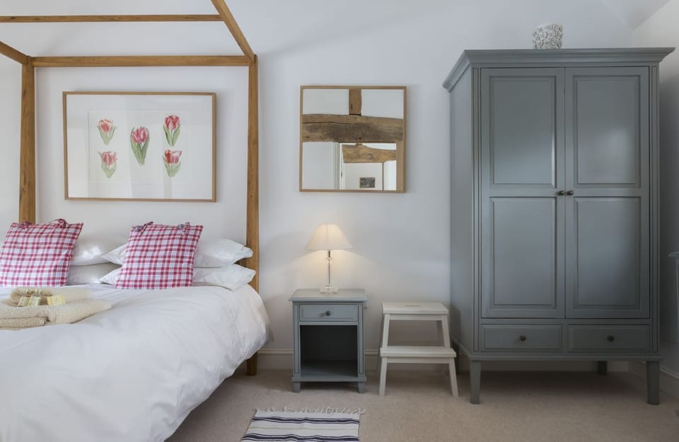 First floor: Bedroom one with king-size four-poster bed