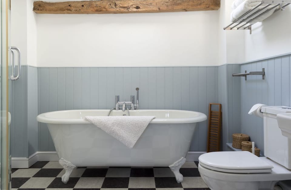 First floor: Bathroom with a roll-top bath and separate shower