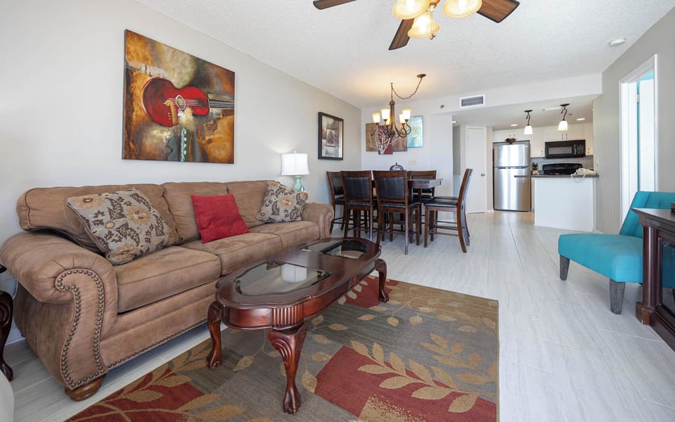 Open living space with comfortable seating, sofa with queen sleeper, vibrant decor, and a dining area
