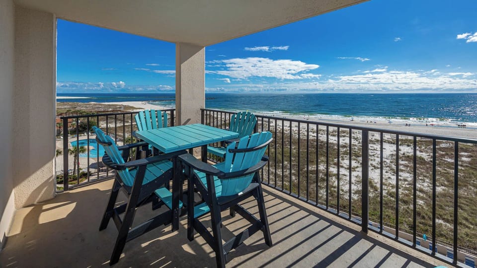 Enjoy your morning coffee at the outdoor table while taking in the beautiful beach views from your balcony