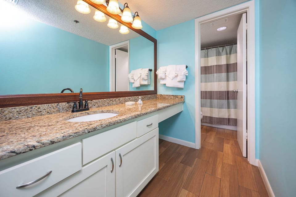 Bright and inviting, the master bathroom features a spacious vanity, stylish lighting, and a relaxing color scheme
