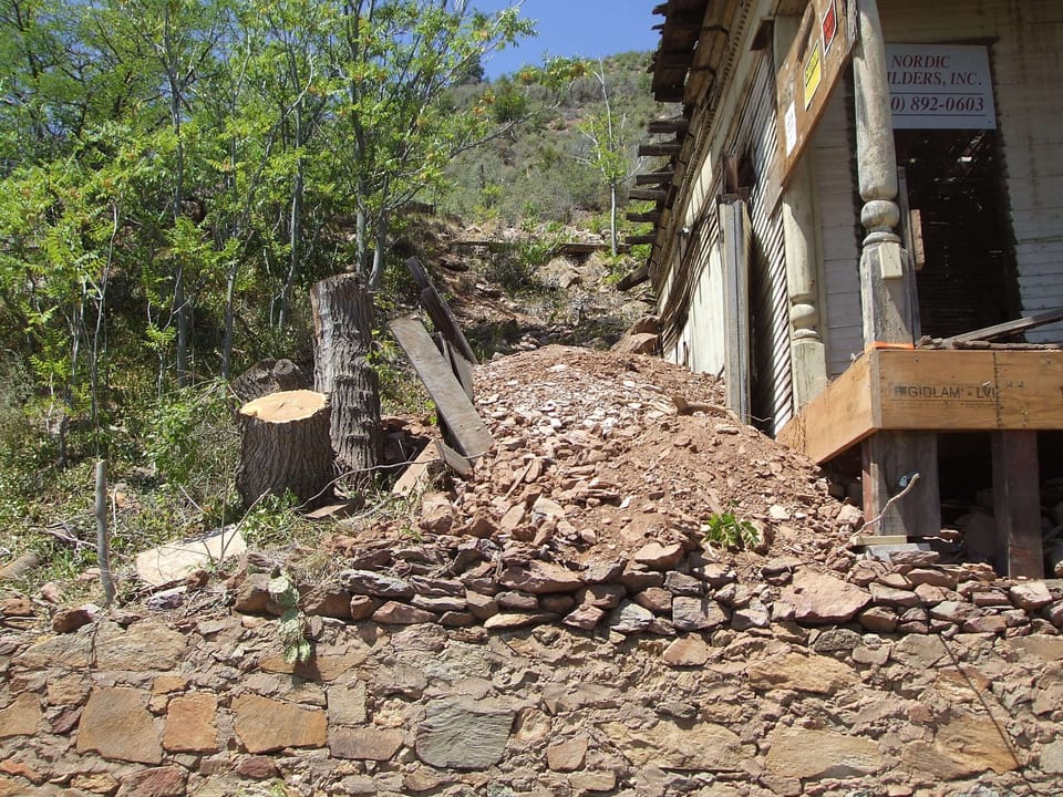 Left side of house before restoration. New parking area located here.