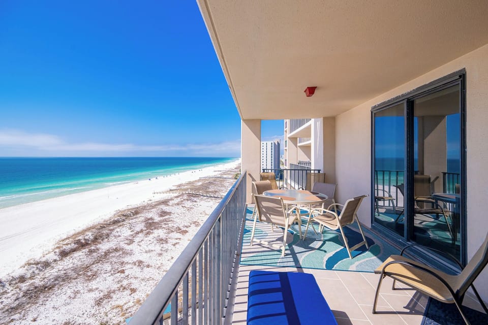 Gaze across the coast from your balcony as gentle waves whisper beneath a vast blue sky
