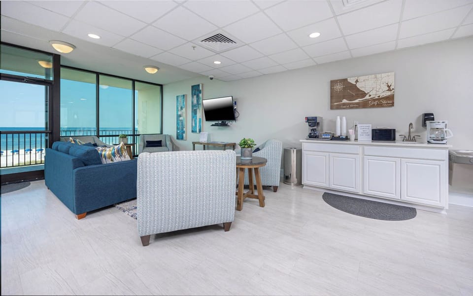 Relax in this inviting lounge with a beachfront view and coffee, perfect for unwinding and planning your next adventure