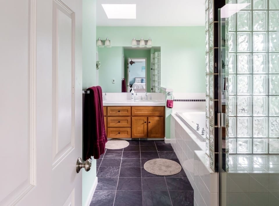 Grand en-suite primary bath has shower, soaking tub, separate toilet, and closet